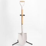 Full image of the white groundbreaking shovel on a stand